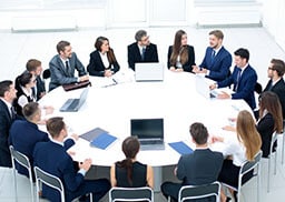 Executives sitting around a round white table